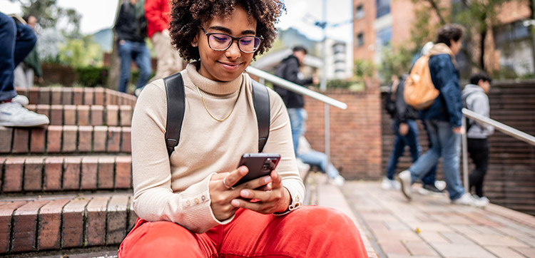 Woman smiling at phone near Rye Heights in Houston, TX